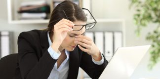 Comprehensive Guide to Preventing Headaches with Eyeglasses: Eyewear Adjustments and Ergonomic Strategies office-worker-suffering-eyestrain-at-work