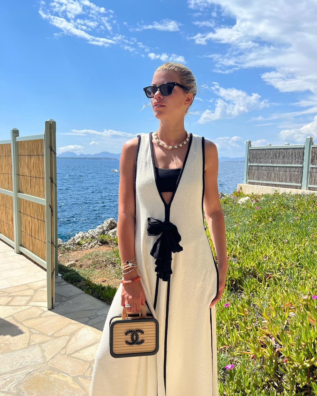 Sofia Richie wearing a white ensemble and beautiful sunglasses.