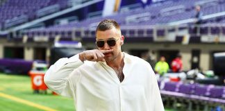 Inside Travis Kelce’s Playbook: Pre-Game Outfits, Sunglasses, & Romance Travis Kelce wearing sunglasses and sporting his signature pose.