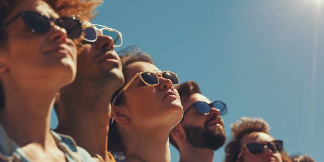 group of people looking at the blue sky with glasses on people wearing photochromic lenses