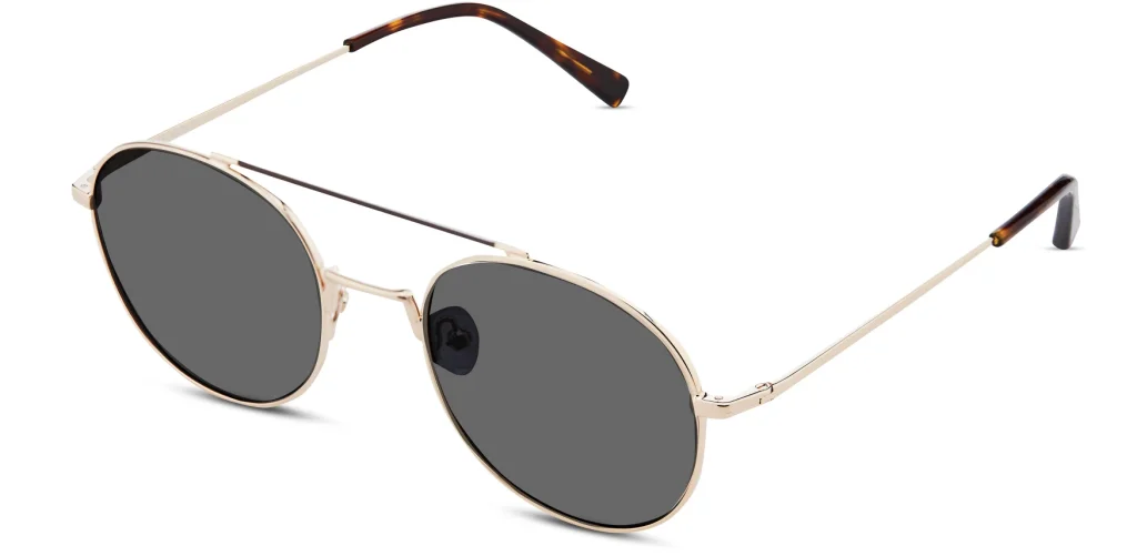 Lindsey sunglasses in Gold with a round metal frame and dark lenses.
