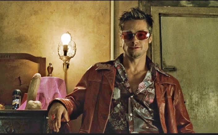 Tyler Durden wearing red-tinted sunglasses and a red leather jacket in Fight Club.