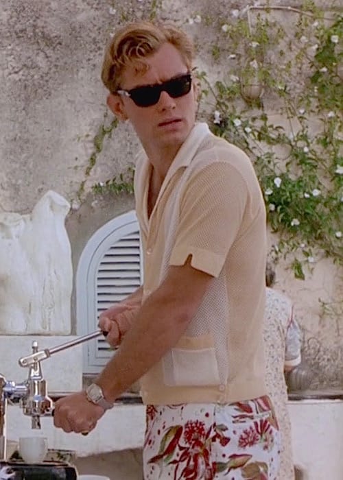 Dickie Greenleaf wearing black sunglasses, a short-sleeved knit shirt, and patterned swim trunks in The Talented Mr. Ripley.